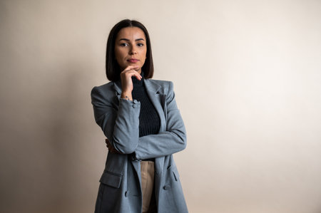 Portrait of young gorgeous businesswoman wearing a suite in studioの写真素材