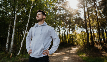 Jogging male fitness model working out training for marathon on forest road in amazing nature landscape.の写真素材