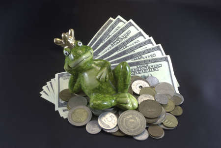 Frog on the money on black backgroundの写真素材