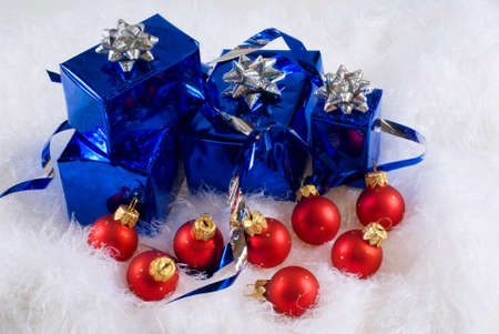 Blue boxes and Christmas red balls on the white skinの写真素材