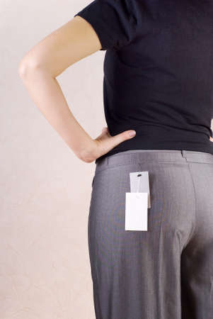 Trying on of grey trousers in shop