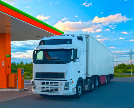 White truck is at the fuel station in sunny summer dayの写真素材