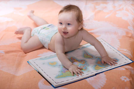 Toddler with books of the world mapsの写真素材