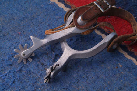 horse riding spurs on blanket with leather strapsの写真素材