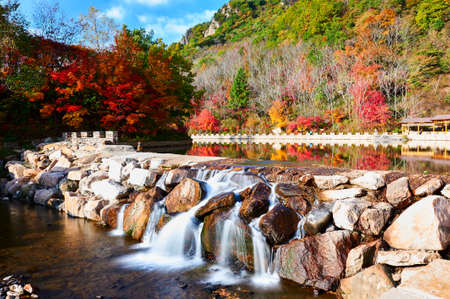 The waterfall in the autumn valleyの写真素材