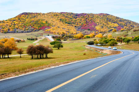 Ther road and autumn colorful mountains scenicの写真素材