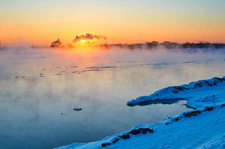 The winter lake sunrise landscape.の写真素材