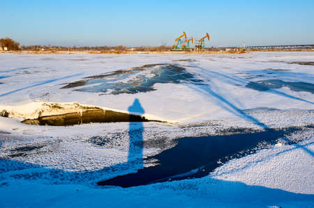The winter lake ice and snow sunset scenicの写真素材