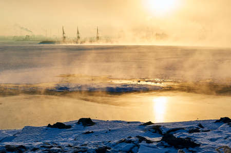 The oil sucking machines in the vapour lakeside under sunrise.の写真素材