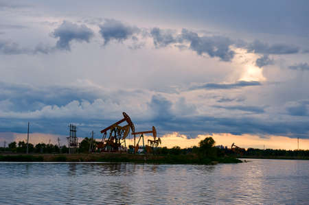 The oil field lake and cloudscape sunset.の写真素材