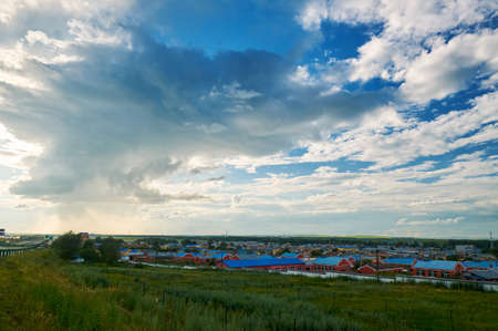 The beautiful cloudscape and town on the summer grassland.