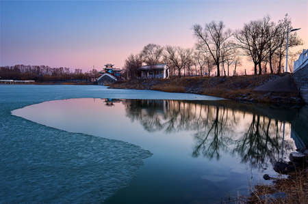 Melting ice on lake in the park.の写真素材