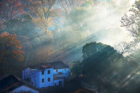 he morning fog on the dwellings of Anhui buildings in Wuyuan county Jiangxi province, China.の写真素材