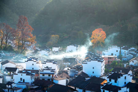 he morning fog on the dwellings of Anhui buildings in Wuyuan county Jiangxi province, China.の写真素材