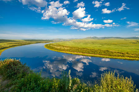 the Hulunbuir Prairie in China's Inner Mongolia Autonomous Region ushered in the most beautiful season. Near Shiwei, a small town on the Sino-Russian border, green grass and wild flowers are in full bloom.の写真素材
