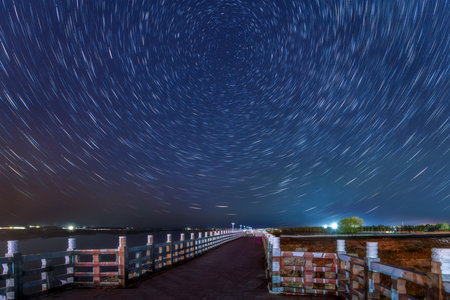 The star trails above the embankment of Nenjiang River on the outskirts of Nenjiang City, Heihe City, Heilongjiang Province, China.の写真素材