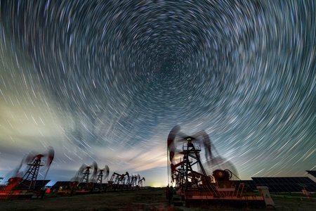 Pumping units under the starry sky at Daqing Oilfield, Daqing, Heilongjiang Province, Chinaの写真素材