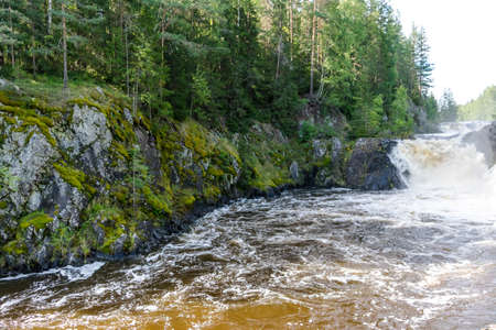 waterfall and river in green forest, famous tourist attractionの写真素材