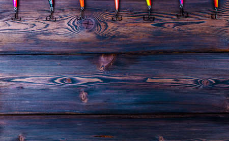 Fishing hook on a background of woodの写真素材