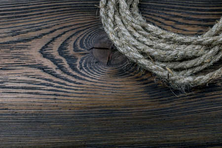 Dark wooden background texture with old ropeの写真素材