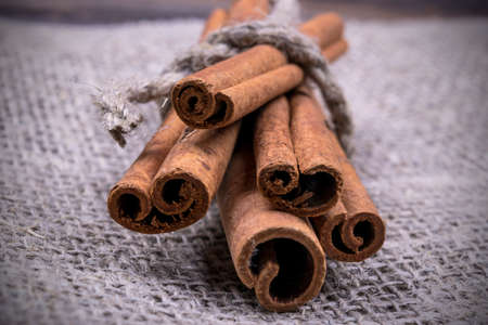 Cinnamon sticks on sackcloth, close upの写真素材