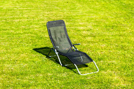 beach chair on the grass on a sunny dayの写真素材
