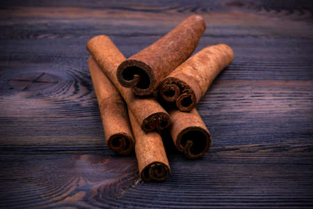 Cinnamon sticks on wooden background texture, close upの写真素材