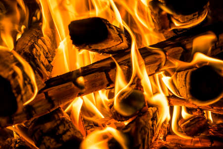 Burning firewood in the BBQ fireplace close up, backgroundの写真素材