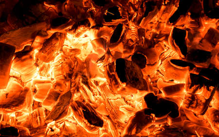 Burning firewood in the fireplace close up, BBQ fire, charcoal background