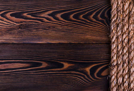 old natural rope texture on wooden plank background