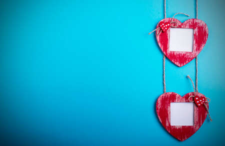 Love card template with blank photo frame heart shaped on the red hearts on blue backgroundの写真素材