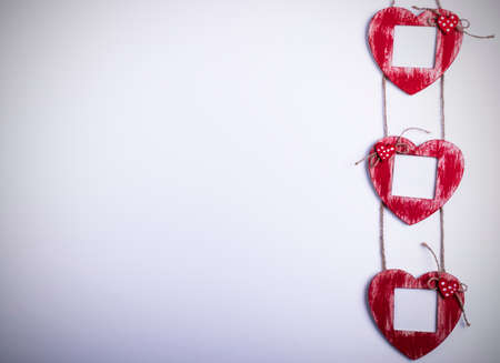 Love card template with blank photo frame heart shaped on the red hearts on white backgroundの写真素材