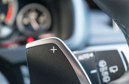 manual gear changing stick on a car's steering wheel, car interior detail