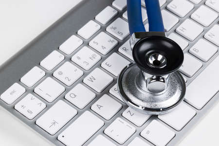Medical stethoscope on computer keyboard. Concept of computer support.