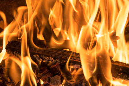 Burning firewood in the fireplace close up, BBQ fire, burning charcoal background, barbeque grillの写真素材
