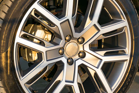 Tire and alloy wheel of a modern car on the ground, car exterior detailsの写真素材
