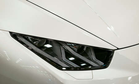 Headlight of a modern sport car.The front lights of the car. Modern Car exterior details