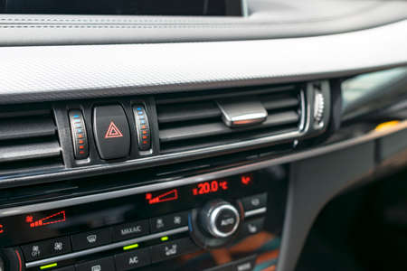 Car hazard warning flashers and emergency button with visible red triangle. selective focus....