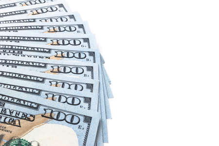 Stack of one hundred dollar bills. Stack of cash money in hundred dollar banknotes. Heap of hundred dollar bills on white backgroundの写真素材