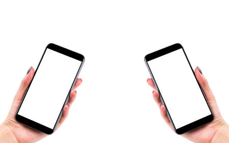 Beautiful Woman hands holding the smart phone with isolated white screen. Business workplace with copy space. Empty space for text. Isolated screen for mock up. Left and right handの写真素材