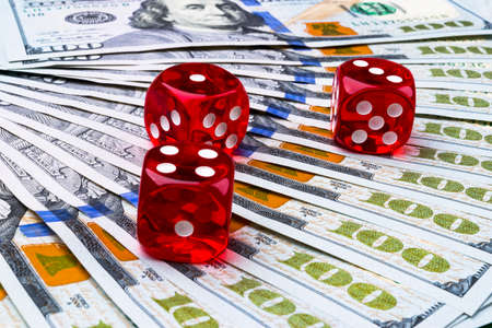 Poker dice rolls on a dollar bills, Money. Poker table at the casino. Poker game concept. Playing a...