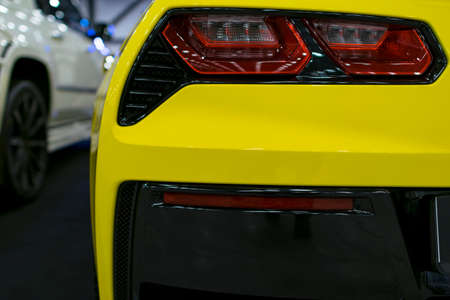 Red Rear light on a modern yellow car with reflection. The Closeup Back Red Tail light carのeditorial素材