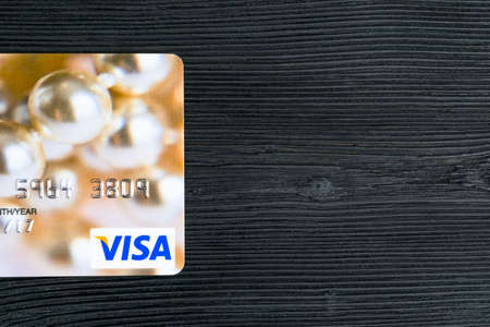 Sankt-Petersburg, Russia, July 09, 2017: Visa credit cards on office black desk board. close up view of a visa credit card on black wooden table. Photo taken in Sankt-Petersburg, Russia, July 09, 2017のeditorial素材