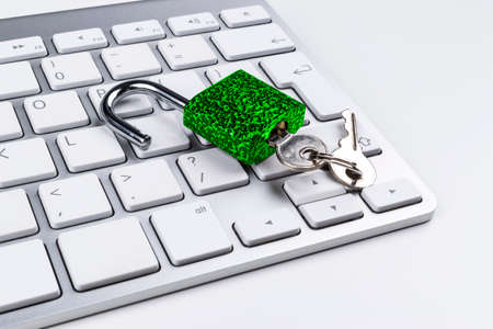 Locked computer safe from virus or malware attack. Laptop computer being protected from online cyber crime and hacking. Computer security concept with a padlock on a keyboard. protection various risksの写真素材