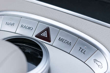Media and navigation control buttons of a Modern car. Car interior details. White leather interior...