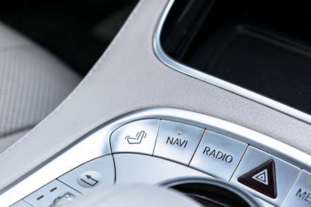 Media and navigation control buttons of a Modern car. Car interior details. White leather interior of the luxury modern car.の写真素材