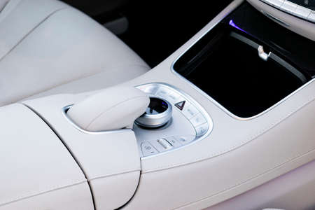 Media and navigation control buttons of a Modern car. Car interior details. White leather interior of the luxury modern car. Modern car interiorの写真素材