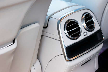 AC Ventilation Deck Luxury Car Interior. Modern car interior details white leather, natural wood.の写真素材