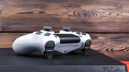 Sankt-Petersburg, Russia, September 24, 2017: Sony PlayStation 4 Slim 1Tb revision and dualshock game controller on the wood backgroundのeditorial素材