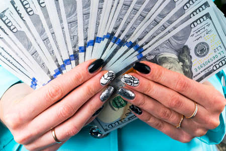 Business woman counting money in hands. Handful of money. Offering money. Women's hands hold money...